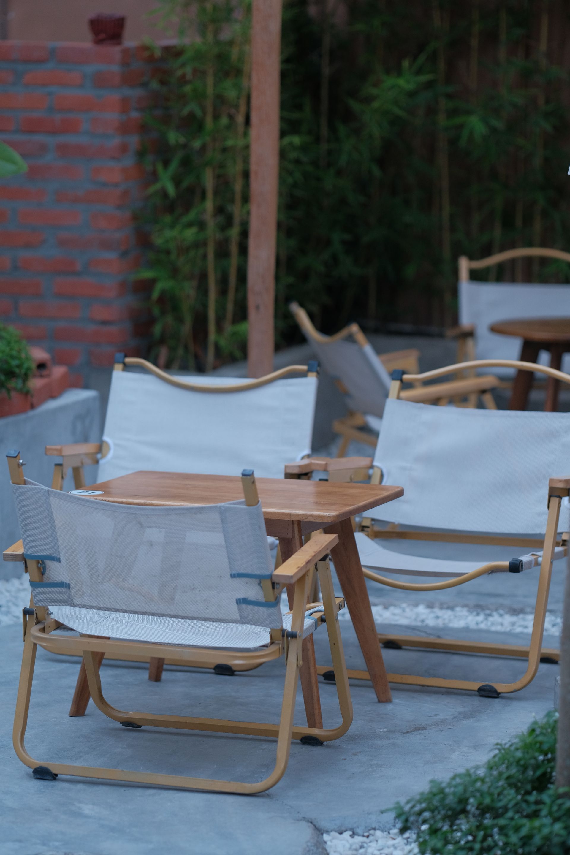 Modern outdoor patio with wooden chairs and table