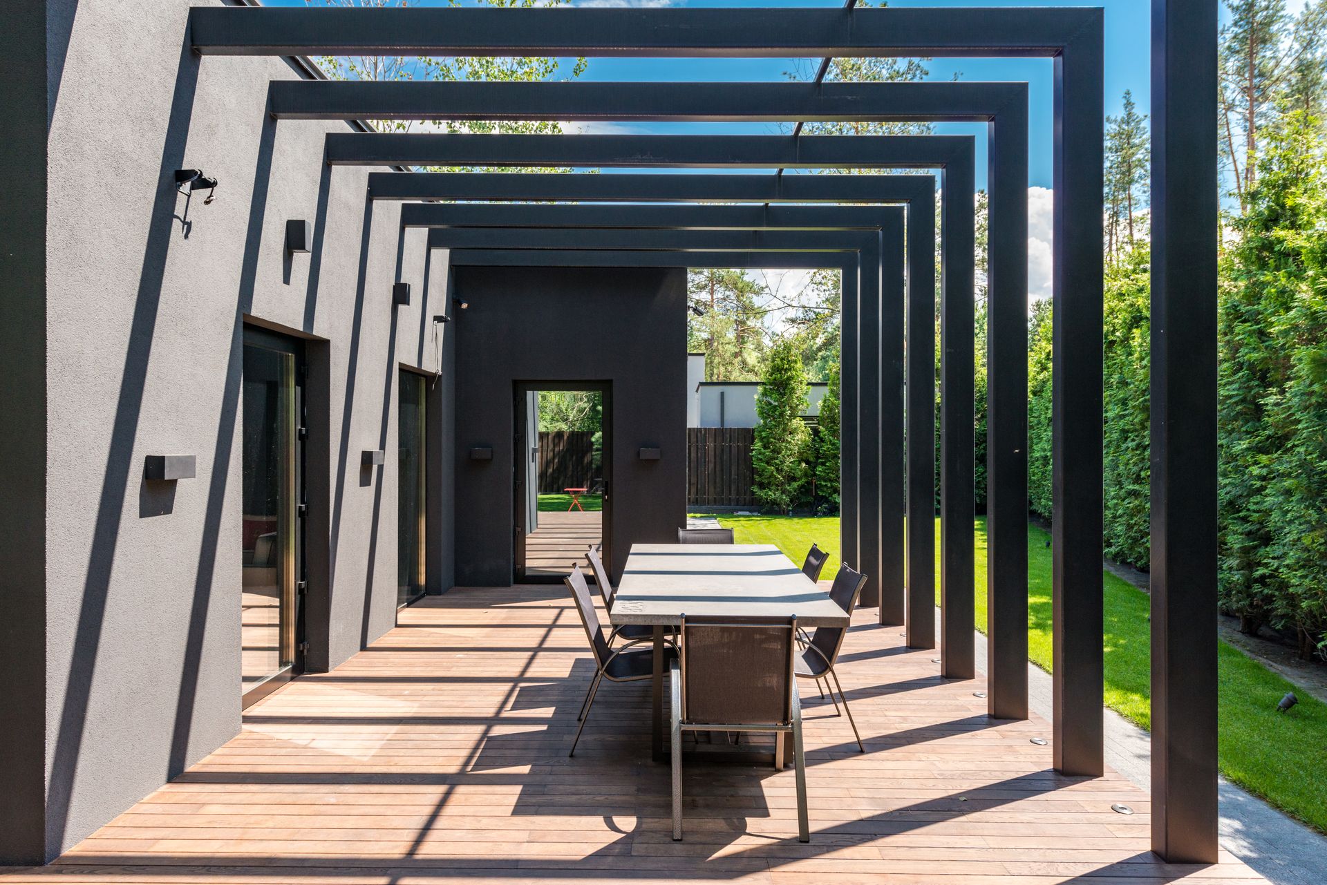 Contemporary patio with pergola and outdoor dining set